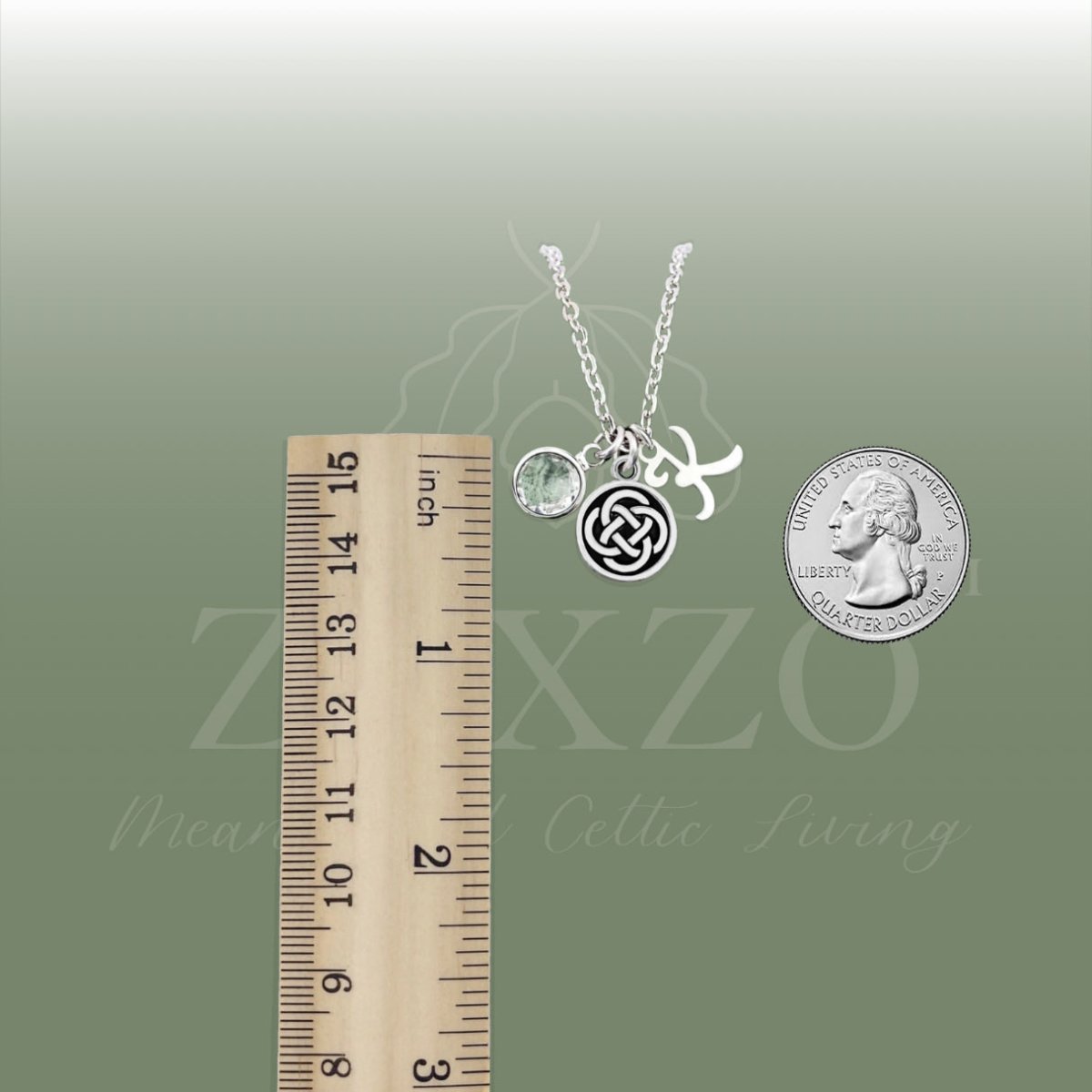 Dara knot birthstone and letter necklace with cable chain between ruler and coin