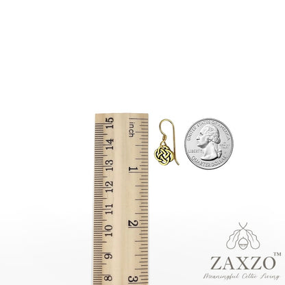 Gold French ear wire with tiny Dara knot between a ruler and quarter.