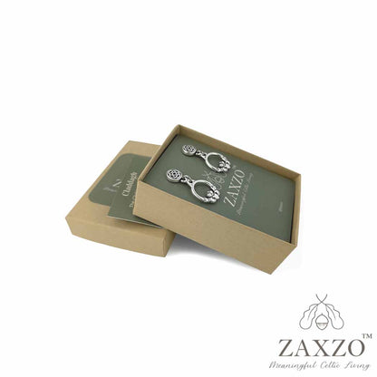 Platinum post silver Claddagh earrings in open gift box with card explaining the meaning.