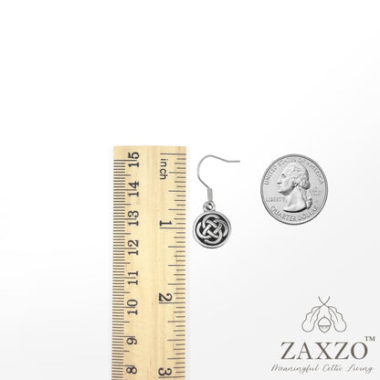 Small Celtic silver Dara knot earring on French wire between ruler and quarter.