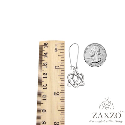 Fine silver plate 99.9 sister knot with sterling silver kidney wire between a ruler and quarter.