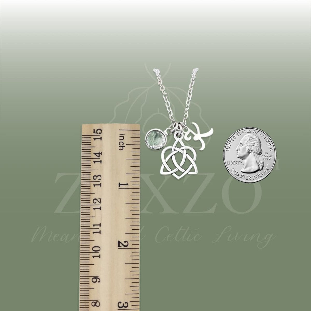 Sister knot birthstone and letter necklace with cable chain between ruler and coin