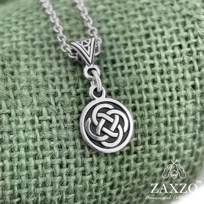 Small gold celtic Dara knot necklace on trinity bail on green background 