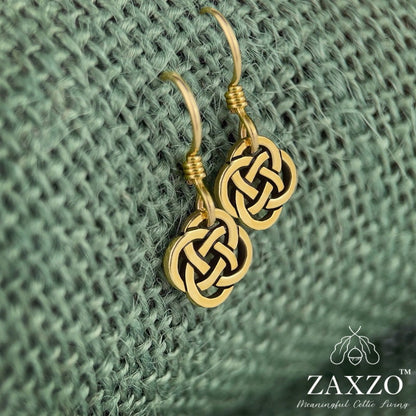 Tiny gold Celtic Dara knot earrings with gold filled ear posts on green background.