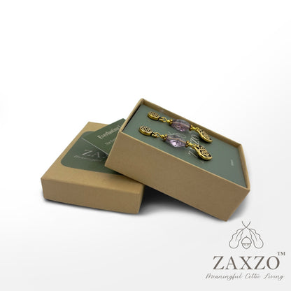 Platinum post gold Everlasting love earrings with organically cut amethyst in open gift box with card explaining the meaning.