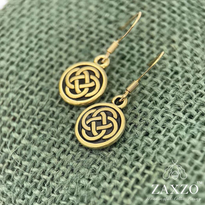 Small gold Celtic Dara knot earrings with French ear wire on green background.