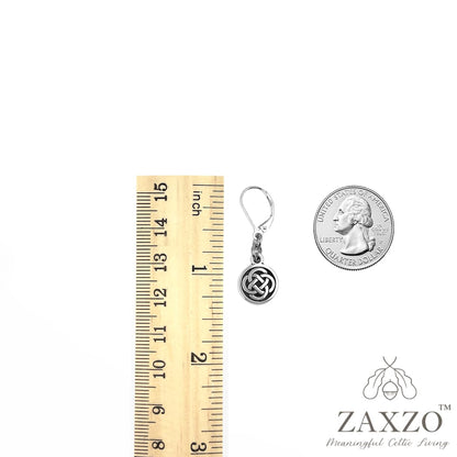 Silver small dara knot lever back earrings shown between ruler and quarter