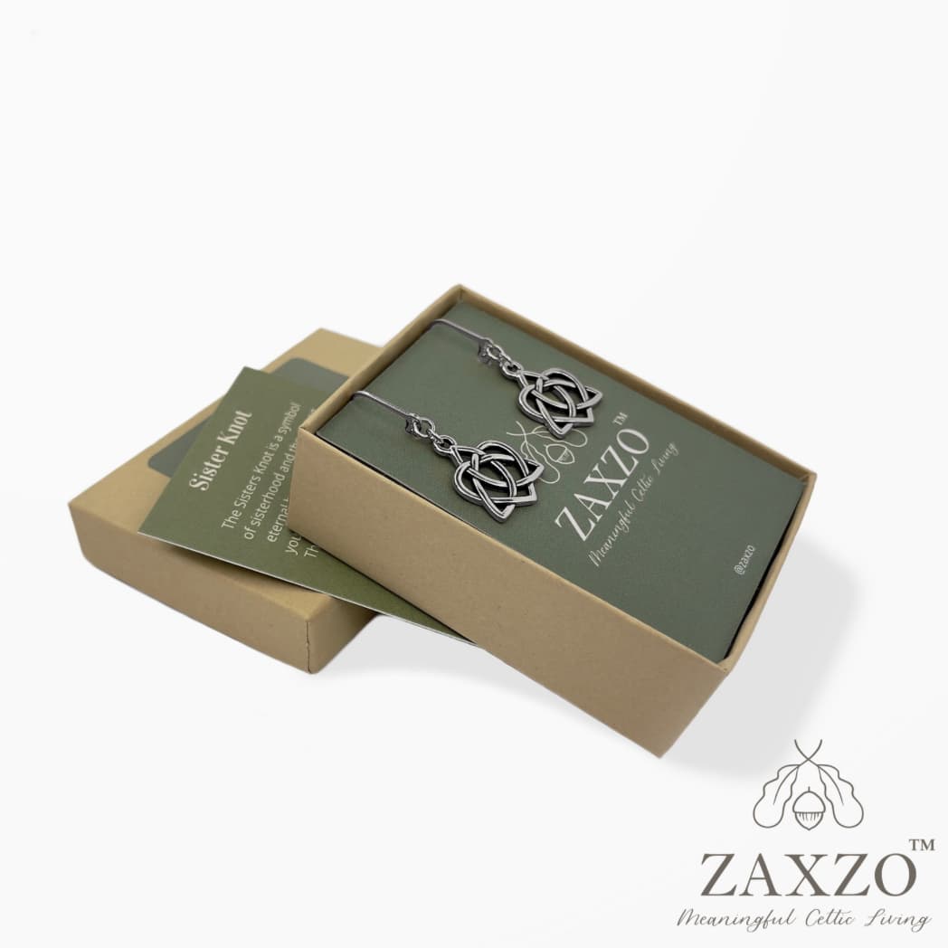 Sister knot earrings shown I open jewelry box on a green jewelry card placed in its gift box arranged partially om the lid of the box with with lore description card.
